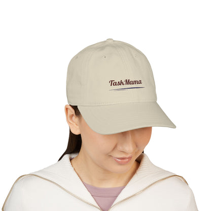 Person wearing a beige cap with 'Task Mama' text on a white background