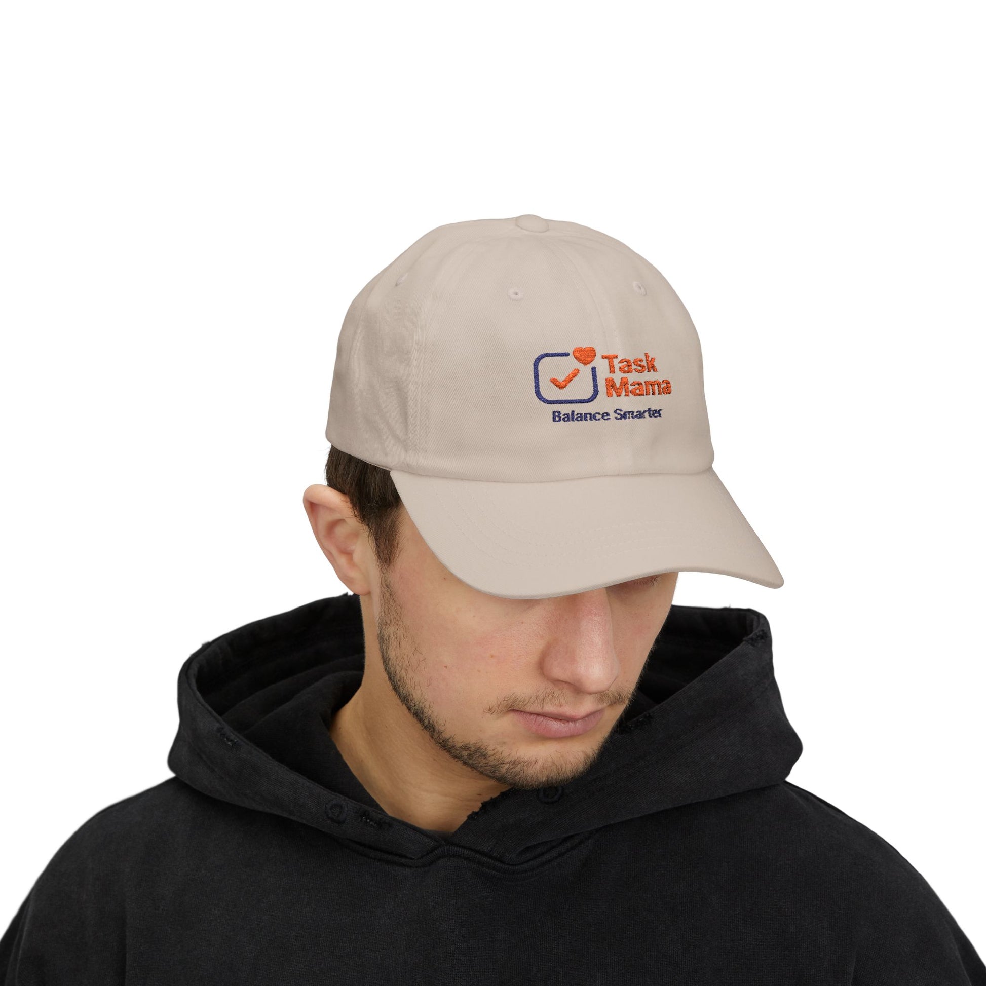 Man wearing a beige cap with a logo on a white background