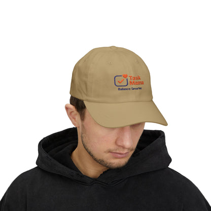 Man wearing a beige cap with an embroidered logo on a white background