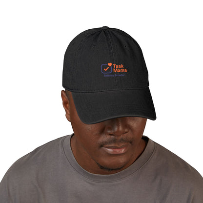 Man wearing a black cap with 'Task Mama' logo on a white background
