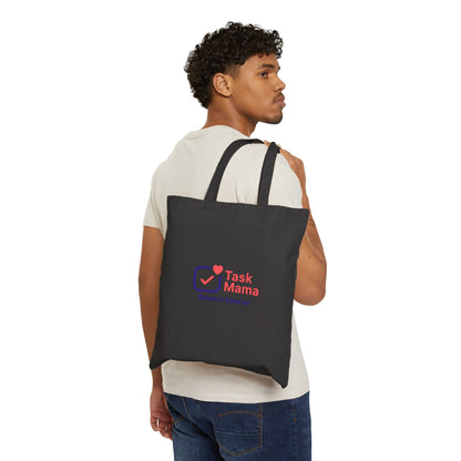 Man carrying a black tote bag with 'Task Mama' logo on a white background