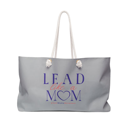 Gray tote bag with 'Lead Like a Mom' text on a white background