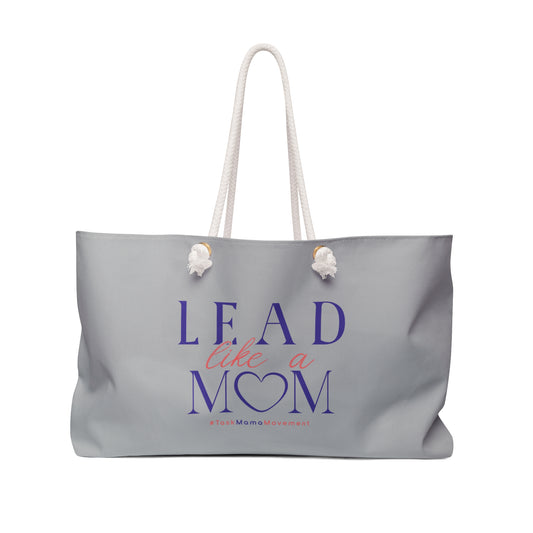 Gray tote bag with 'Lead Like a Mom' text on a white background