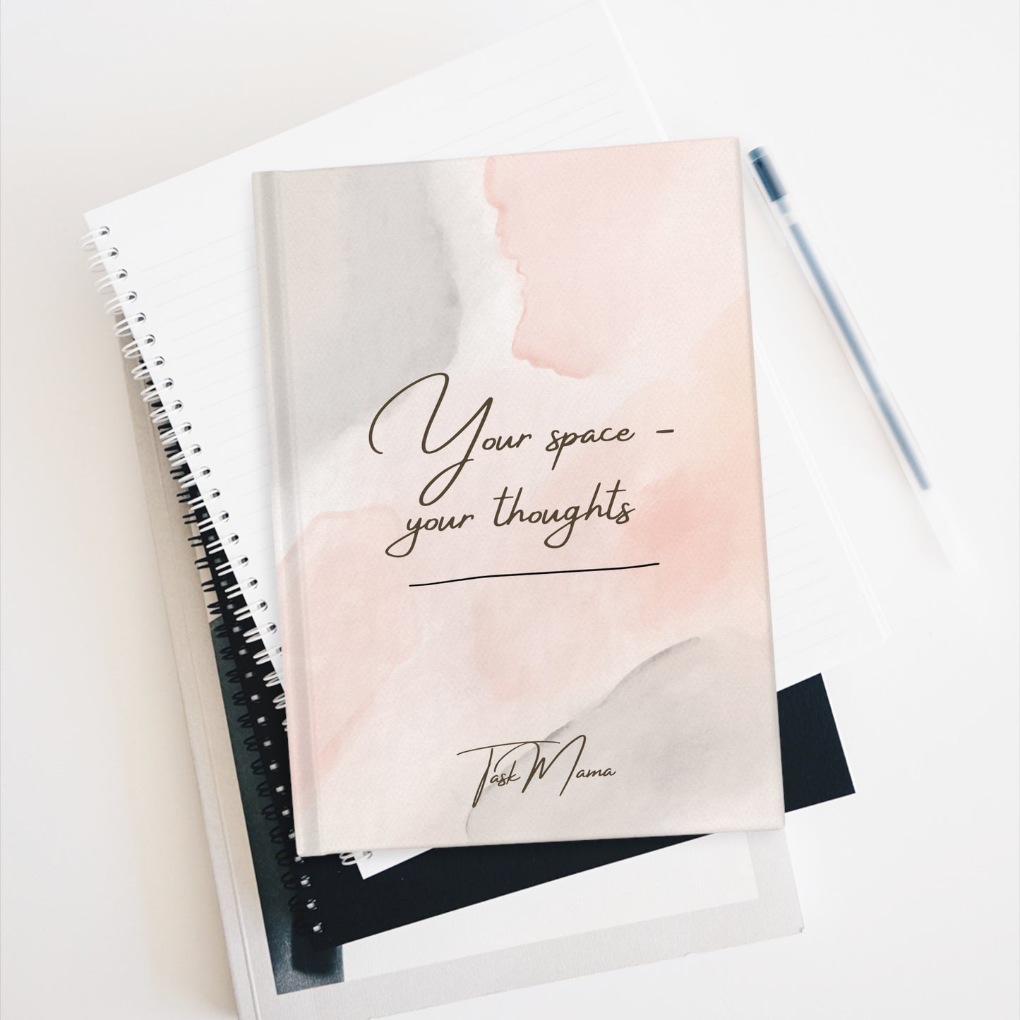 Notebook with 'Your space, your thoughts' text on a light background