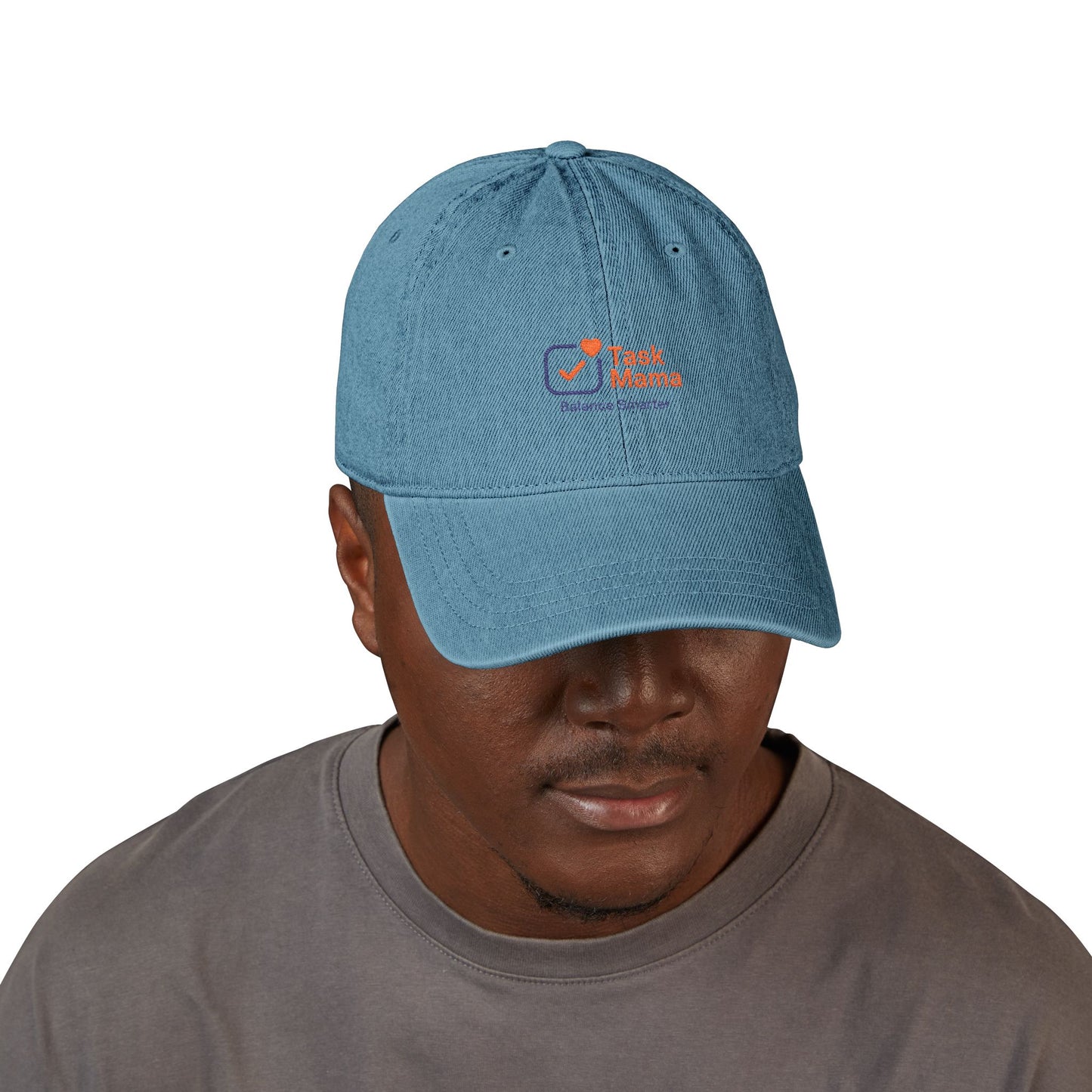 Man wearing a blue cap with a logo on a white background