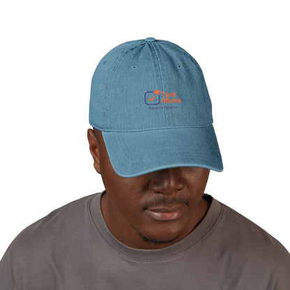 Man wearing a blue cap with a logo on a white background
