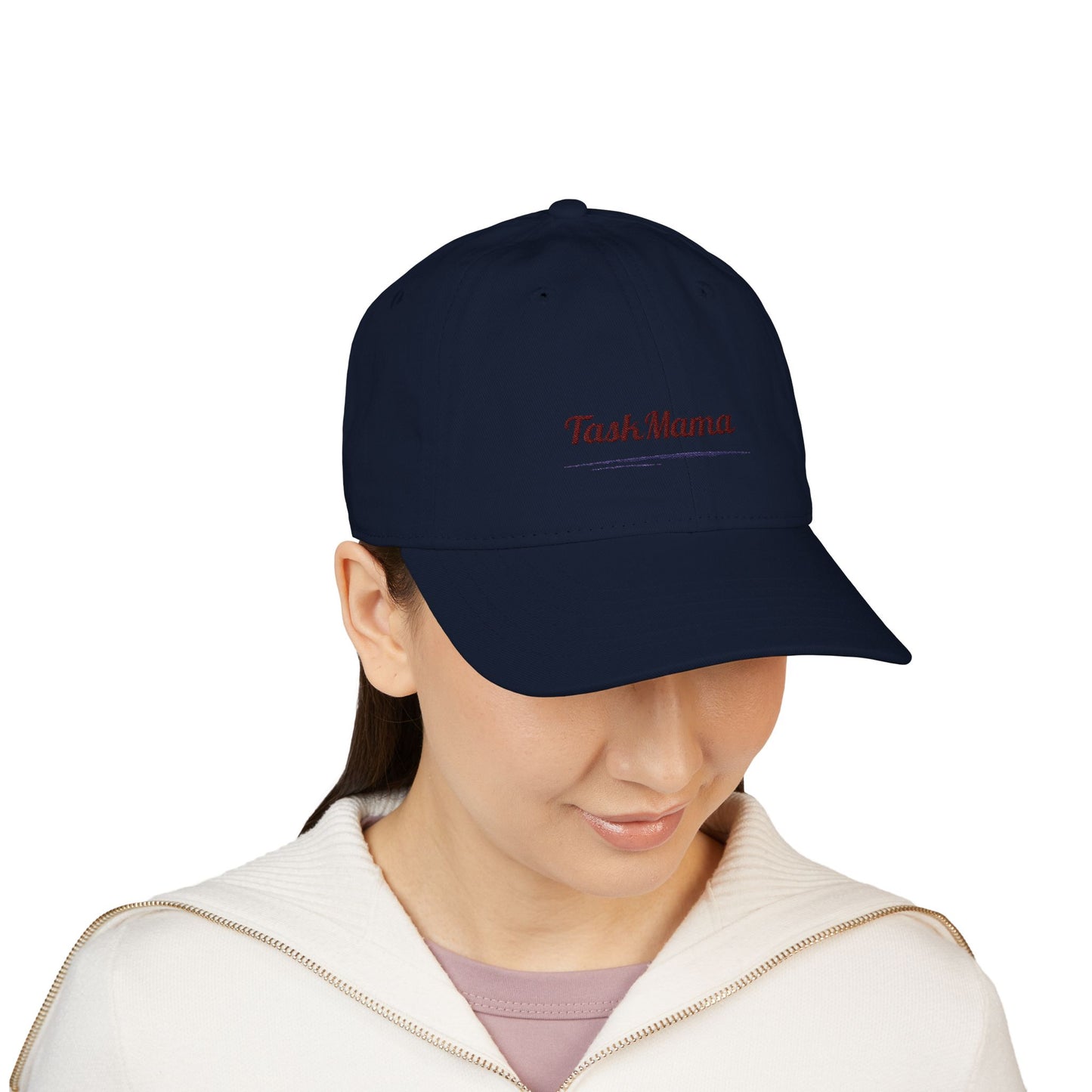 Person wearing a navy blue cap with 'Tash Mama' text on a white background