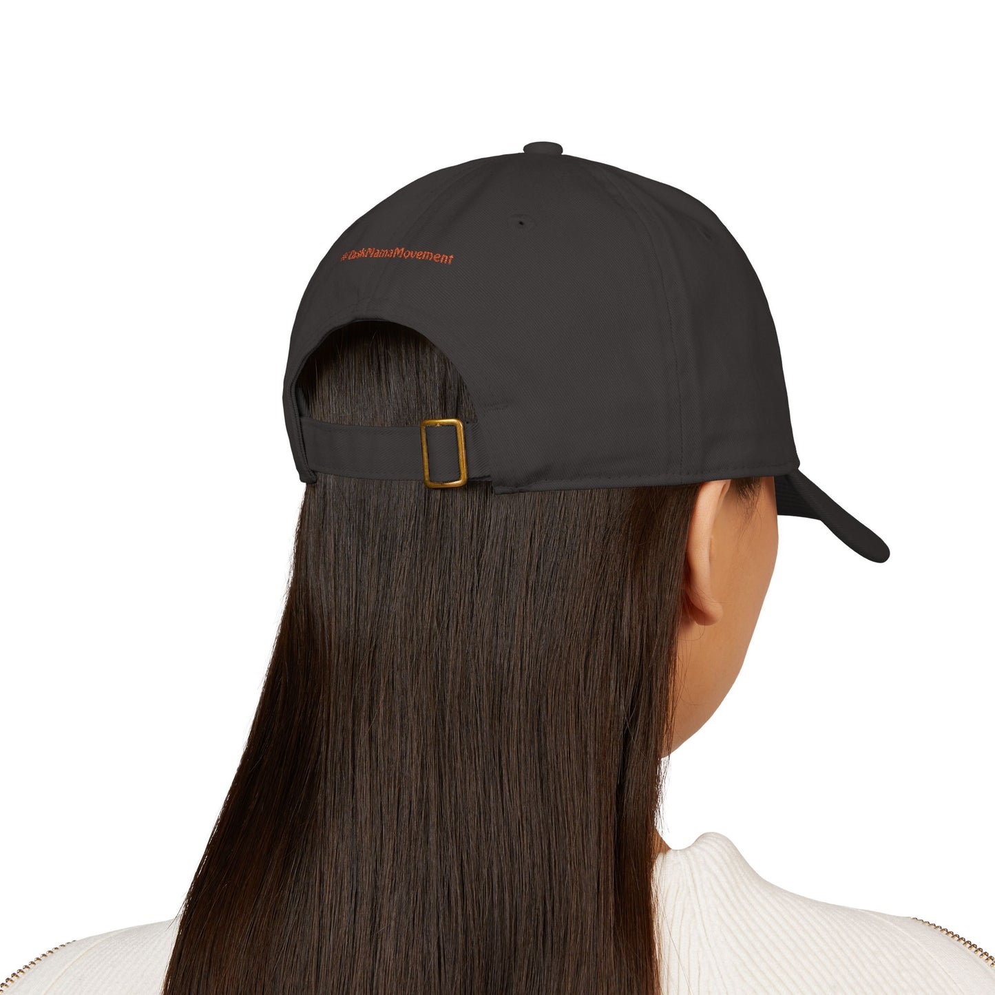Person wearing a black cap with a brand logo on the back, on a white background