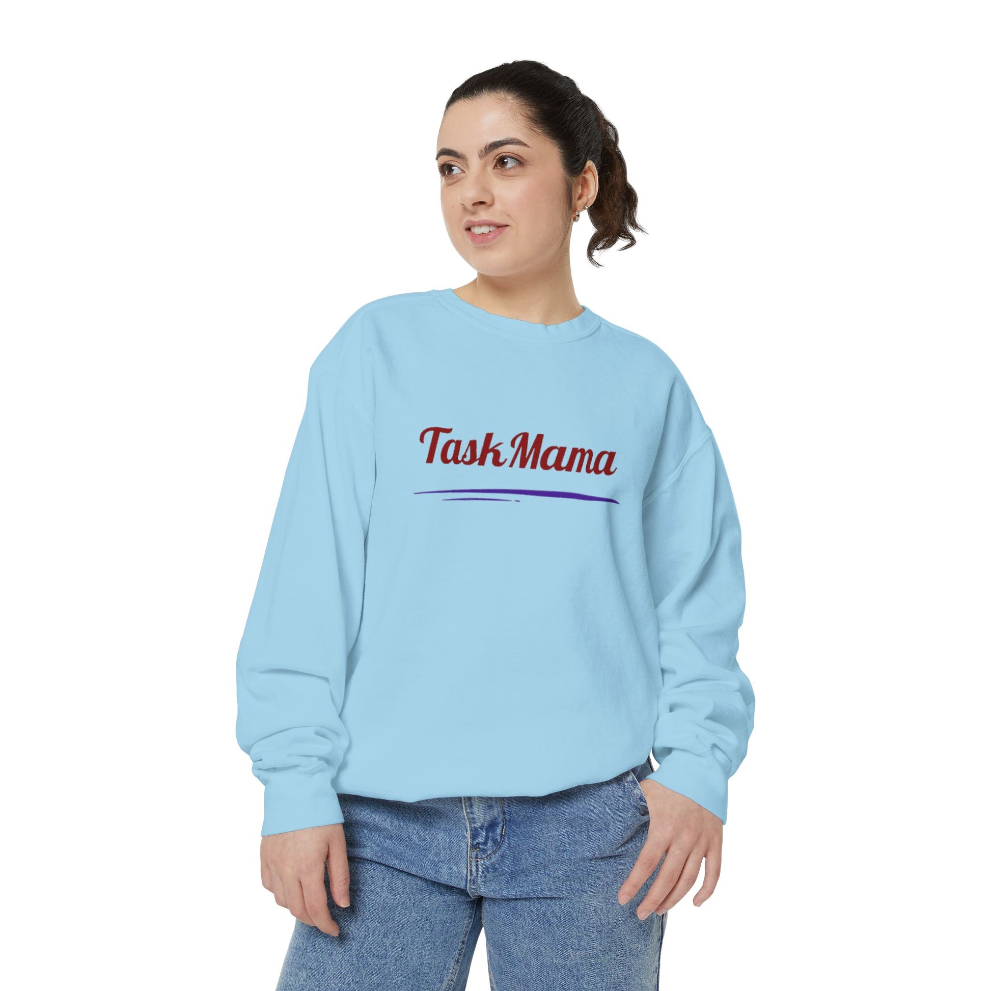 Woman wearing a light blue sweatshirt with 'Task Mama' text on a white background