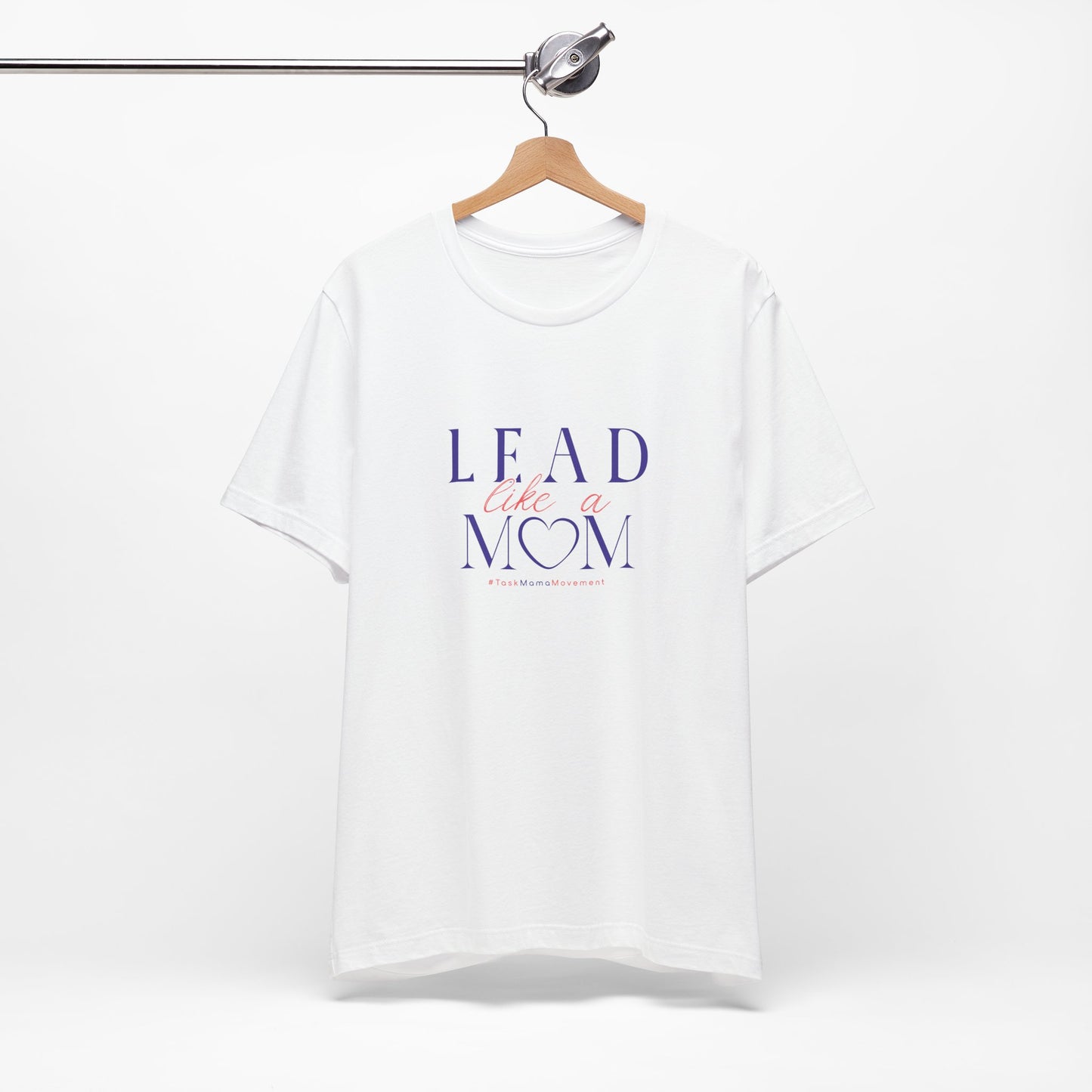 White t-shirt with 'Lead Like a Mom' text on a hanger against a white background