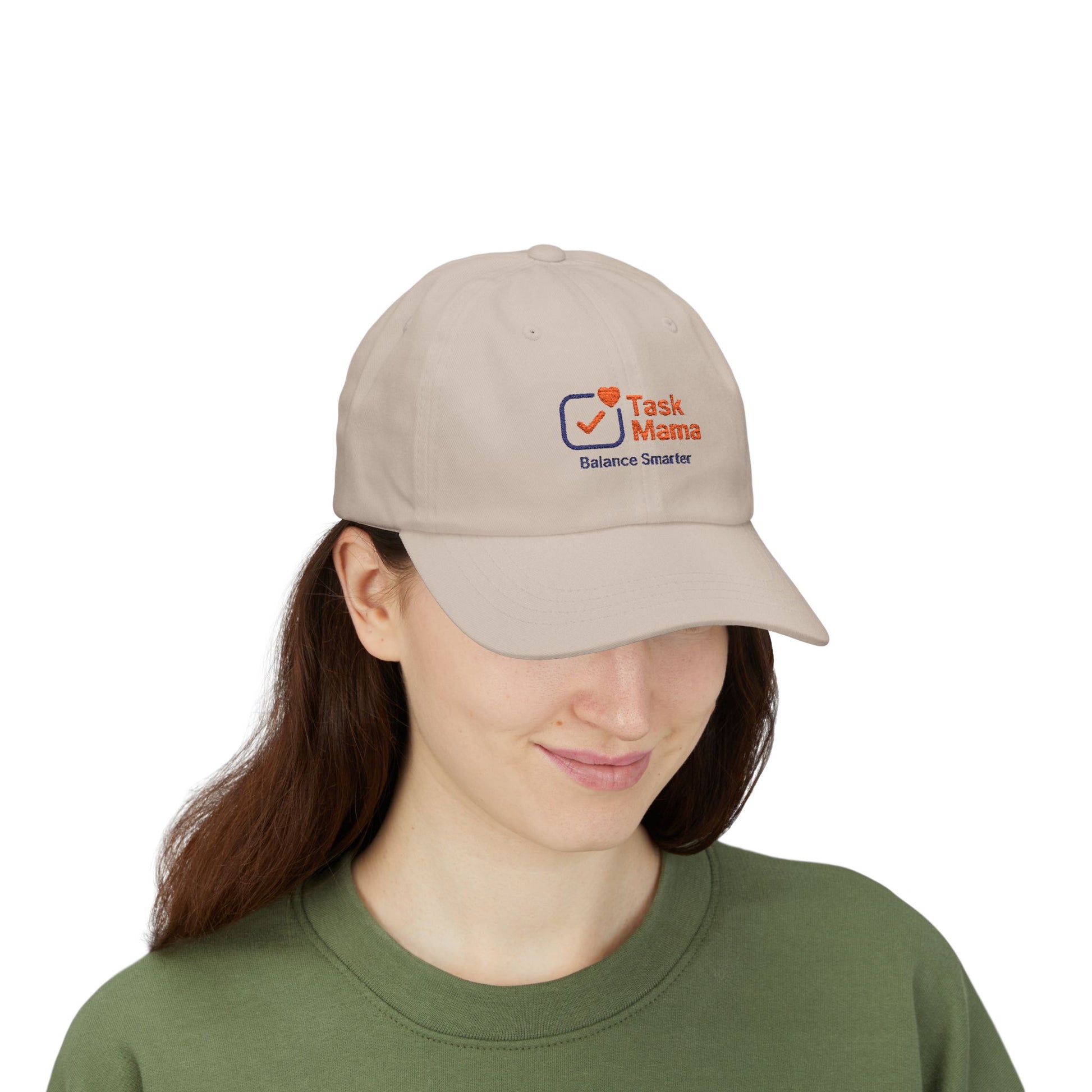Person wearing a beige cap with a logo on a white background