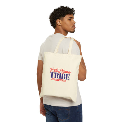 Man carrying a tote bag with 'Tasty Mama Tribe' text on a white background