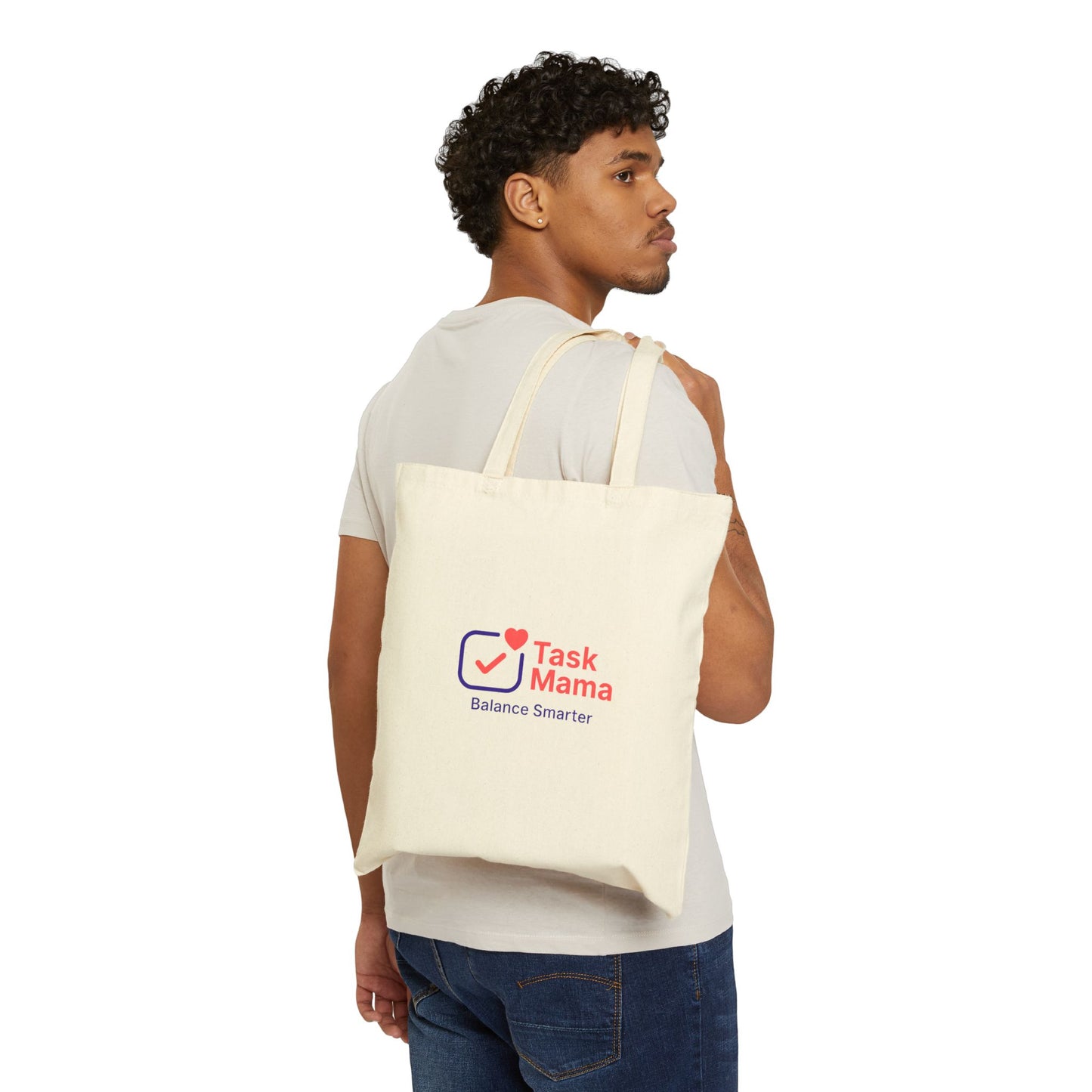 Man carrying a tote bag with 'Task Mama' logo on a white background