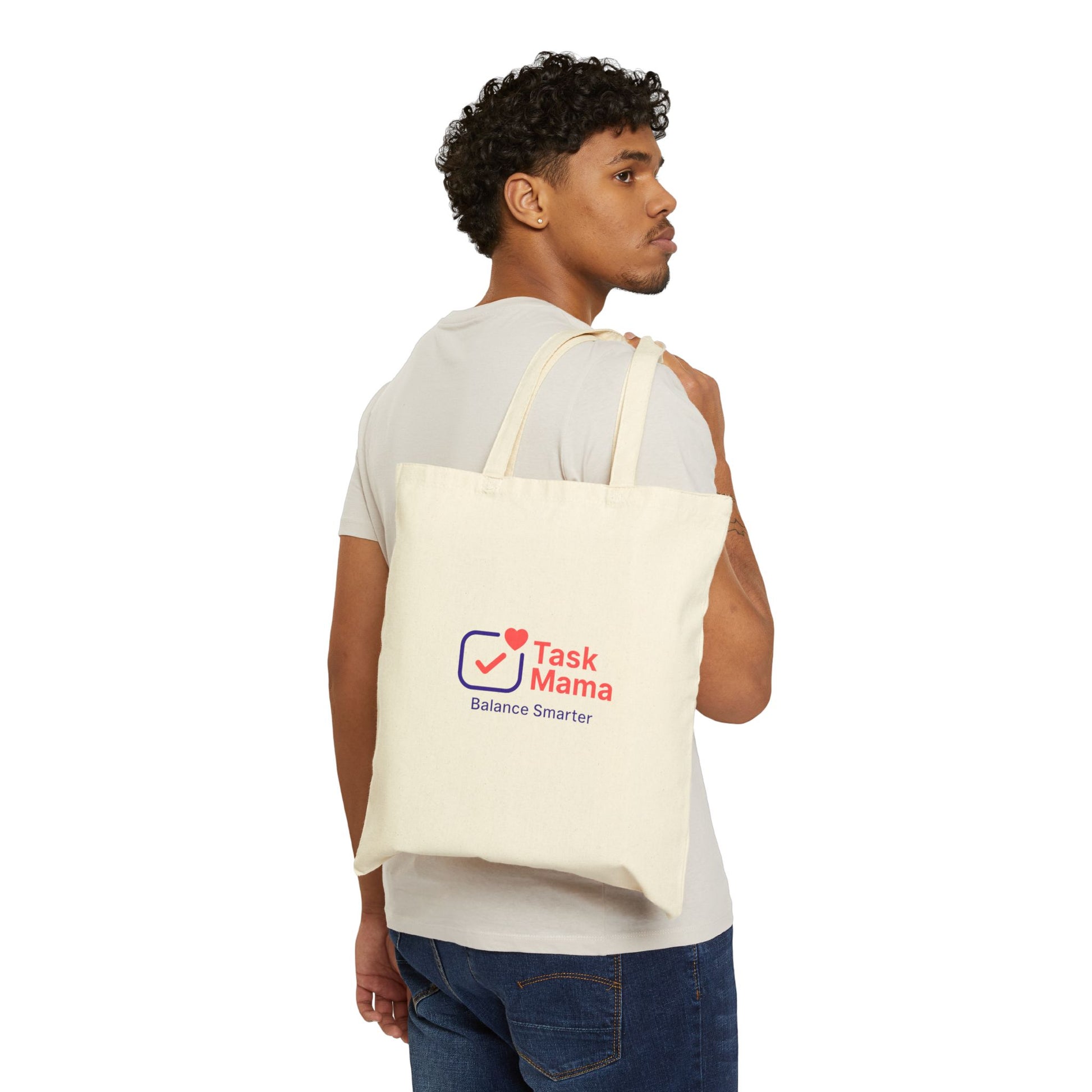 Man carrying a tote bag with 'Task Mama' logo on a white background