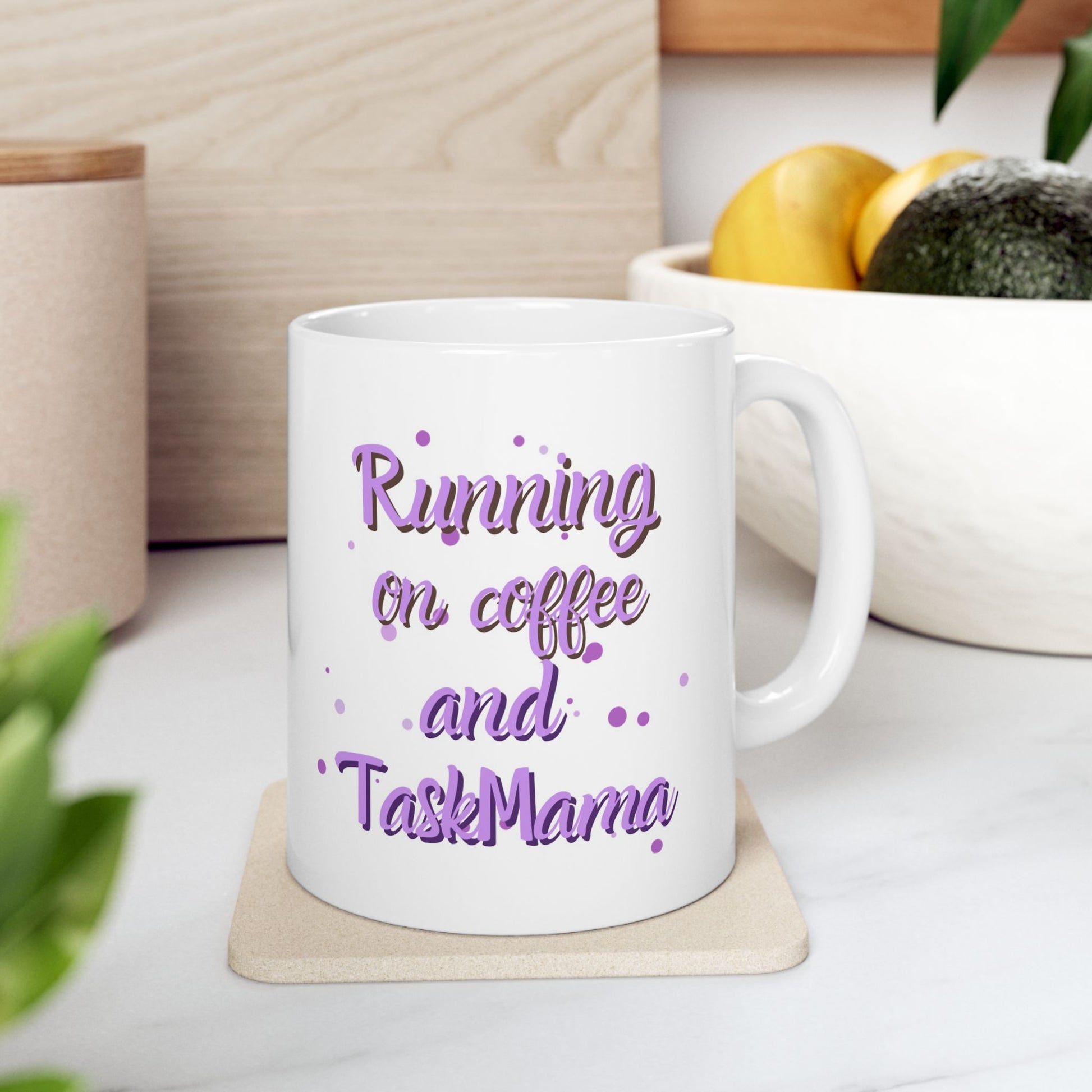 White mug with 'Running on coffee and TaskMama' text, surrounded by Halloween-themed treats and pumpkins.